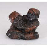 A JAPANESE CARVED WOOD ""MASK MAKER"" NETSUKE.