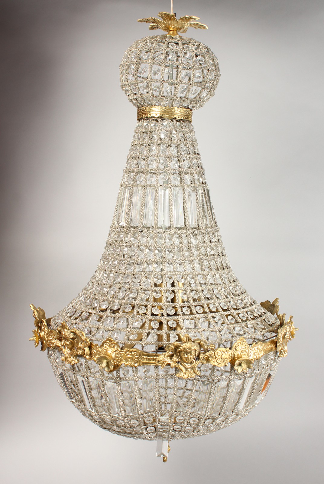 A CUT GLASS AND ORMOLU CHANDELIER. 39ins high.