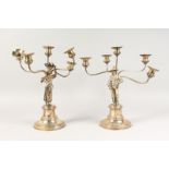 A PAIR OF CONTINENTAL SILVER CANDELABRA, with five scrolling branches, the stems with a man and