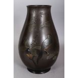 A SIGNED JAPANESE MEIJI/TAISHO PERIOD MIXED METAL VASE, decorated with birds perched on a leafy