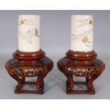 A PAIR OF JAPANESE MEIJI PERIOD IVORY TUSK VASES, together with fitted wood stands, each vase carved