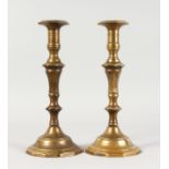 A PAIR OF 18TH CENTURY FRENCH CAST BRASS CANDLESTICKS. 11ins high.
