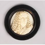 A EUROPEAN CARVED IVORY PLAQUE. Signed Addisson. 2ins diameter, in a wooden frame.