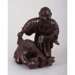 A JAPANESE CARVED WOOD OKIMONO, man and boy holding a fox. 3ins high.