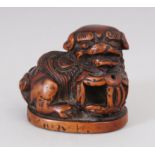 A JAPANESE CARVED WOOD ""SHI SHI"" NETSUKE.