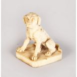 A GOOD EUROPEAN IVORY FIGURE OF A SEATED DOG. 2.25ins high.