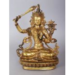 A TIBETAN GILT BRONZE FIGURE OF A BUDDHA, seated in Lalitasana on a lotus plinth. 8.5ins x 6ins.