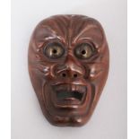 A SMALL JAPANESE BRONZE MASK. 2ins long.