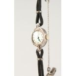 A LADIES BULOVA 14K COCKTAIL WATCH, with double cord strap.