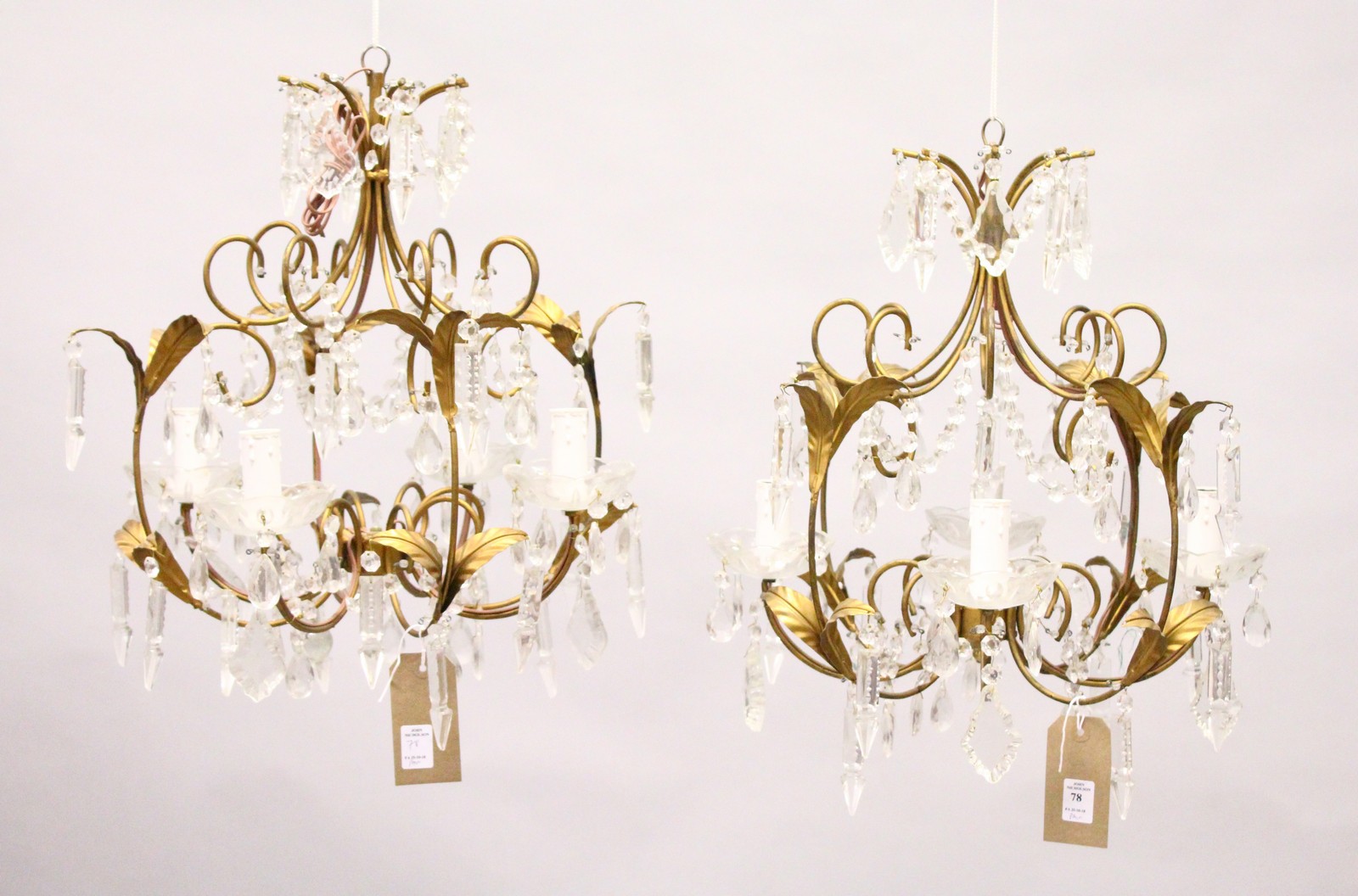 A PAIR OF GILT METAL AND CUT GLASS FOUR BRANCH CHANDELIERS, of naturalistic form with cut glass