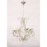 A SILVERED METAL AND CUT GLASS FOUR BRANCH CHANDELIER, with large prism drops and star shape