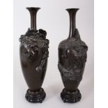 A GOOD SMALL PAIR OF JAPANESE BRONZE VASES, with flowers and fruit in relief. Signed. 7.5ins high,