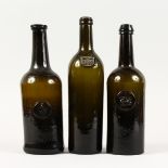 THREE EARLY GREEN BOTTLES, all with a crest, one dated 1788. 11.5ins high.