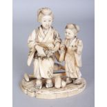 A SIGNED JAPANESE MEIJI PERIOD SECTIONAL IVORY OKIMONO OF A MOTHER & DAUGHTER, the seated mother