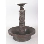 AN UNUSUAL 18TH/19TH CENTURY CHINESE BRONZED COPPER CANDLE HOLDER, with a wide drip pan, the stem