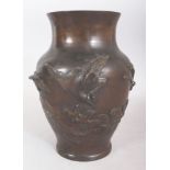 A SIGNED JAPANESE MEIJI PERIOD BRONZE VASE, cast in relief with cranes above waves, the base with