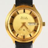 A GENTS VINTAGE BULOVA ACCUTRON WATCH with day-date aperture, on leather strap.