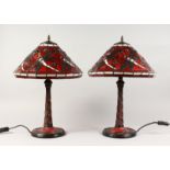 A PAIR OF TIFFANY STYLE RED GLASS DRAGONFLY TABLE LAMPS. 22ins high.