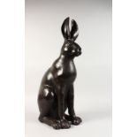 A LARGE BRONZE MODEL OF A SEATED HARE. 23ins high.