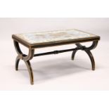 A DECORATIVE ITALIAN STYLE EBONISED-GILDED COFFEE TABLE, with mirrored and gilded, floral