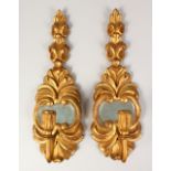 A PAIR OF ITALIAN CARVED AND GILDED WOOD SINGLE SCONCES. 18ins long.