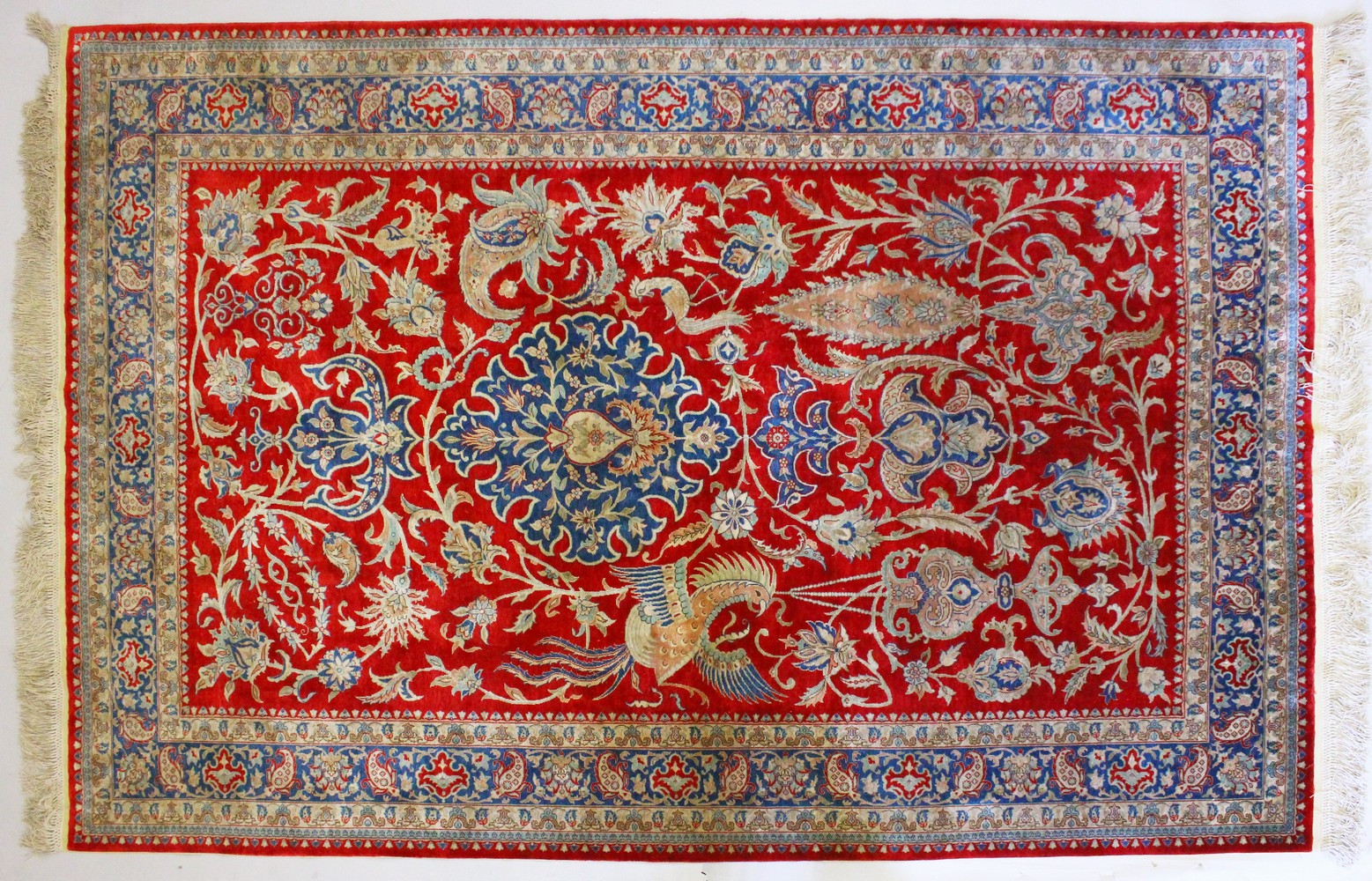 A GOOD PERSIAN PART SILK CARPET, with central motif, phoenix birds and flowers, within a triple