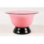 AN ART DECO PINK AND BLACK GLASS CIRCULAR PEDESTAL BOWL. 10ins diameter.