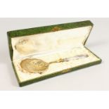 A PIERCED AND GILDED SERVING SPOON, boxed. 10ins long.