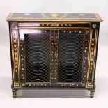 A REGENCY DESIGN EBONISED, PAINTED AND GILDED TWO DOOR BOOKCASE, with a pair of brass grilled doors,