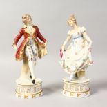 A PAIR OF FRENCH PORCELAIN FIGURES OF A GALLANT AND LADY, on circular bases. 8ins high.