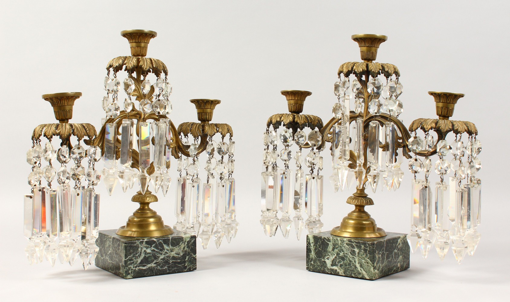 A GOOD PAIR OF 19TH CENTURY THREE-LIGHT CANDLESTICKS, all with prism drops, supported on square