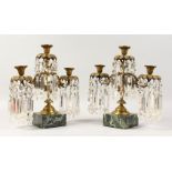 A GOOD PAIR OF 19TH CENTURY THREE-LIGHT CANDLESTICKS, all with prism drops, supported on square