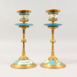 A SMALL PAIR OF FRENCH SEVRES DESIGN GILT METAL AND PORCELAIN CANDLESTICKS. 7ins high.