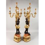 A PAIR OF BLACKAMOOR FOUR-LIGHT CANDELABRA, the stems as Blackamoor figures holding scrolling