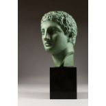 AFTER THE ANTIQUE, a green glazed terracotta bust of a man, on a plinth base. 16.5ins including