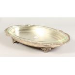 AN OVAL SERVING DISH, with glass liner. 20ins wide.