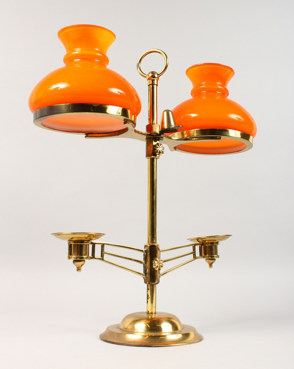 A MODERN BRASS TWO-LIGHT CANDLESTICK, with orange glass shades. 15.5ins high.