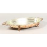 AN OVAL SERVING DISH, with glass liner. 23ins wide.