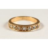 A GOLD HALF ETERNITY RING, set with six diamonds.