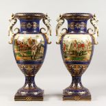 A PAIR OF SEVRES DESIGN RICH BLUE TWO-HANDLED URN SHAPED VASES, with panels painted with soldiers,