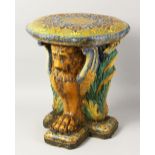 A MAJOLICA POTTERY STOOL AND TABLE, with Islamic decoration, cushion top, the base with lion