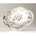 A VICTORIAN OVAL SHAPED TRINKET TRAY, repousse with angel head. 11.5ins long. London 1900.