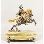 A LIMITED EDITION SILVER AND GILT METAL MODEL OF A HUSSAR ON HORSEBACK, mounted on an onyx base.