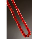 A STRING OF LARGE CORAL BEADS.