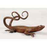 AN UNUSUAL BRONZE COAT HOOK, in the form of a lizard. 9ins high.