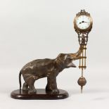 A GOOD ELEPHANT SWING CLOCK, on a wooden base. 10ins high.