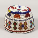 A NORTH AFRICAN BEAD WORK HAT. 4.5ins high.
