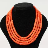 A GOOD FOUR-STRAND CORAL NECKLACE with gold clasp, 118gms.