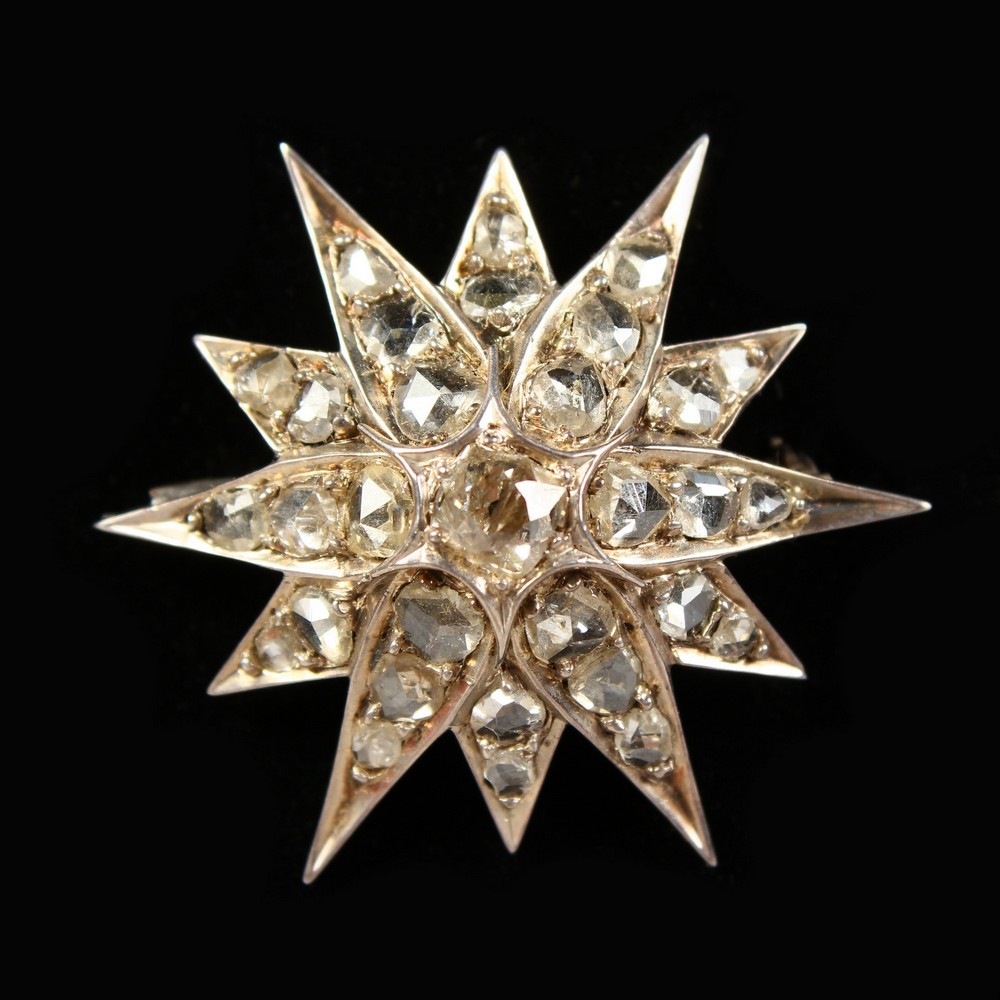 A DIAMOND STAR BROOCH.