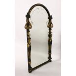 A DECORATIVE PAINTED AND POLISHED BRASS FRAMED OVAL WALL MIRROR, with caryatid figures. 2ft 10ins